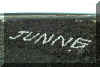 Junne's name spelled out in lava rock on the side of the highway
